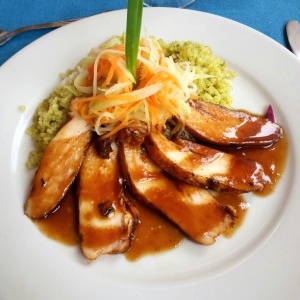 Pollo cajun en salsa de tamarindo y arroz verde.