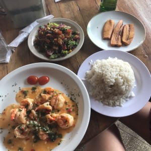 Camarones al ajillo con arroz, ensalada y tajadas. 