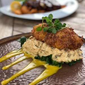 Pollo firto con coco y cama de risotto