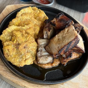 Puerco en cama de tamal con patacones